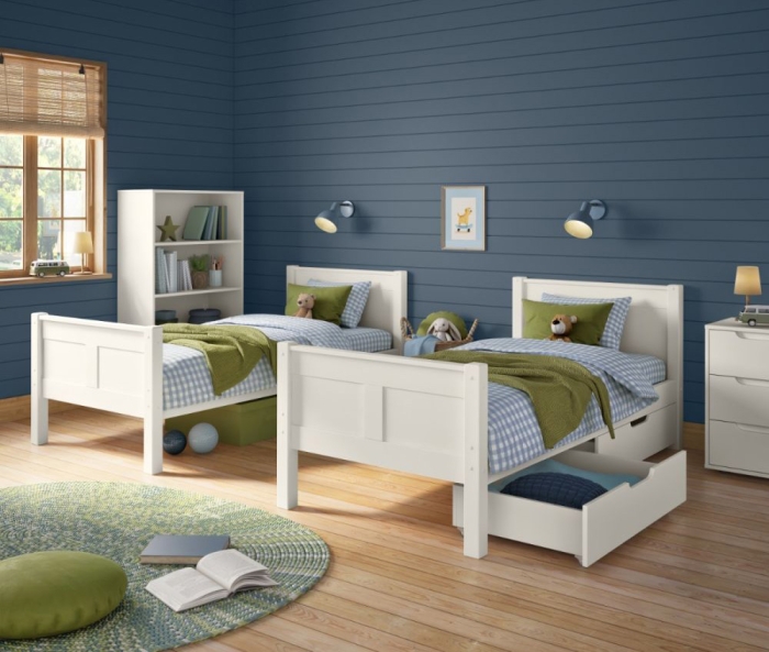 White single beds with matching storage furniture in a shared bedroom