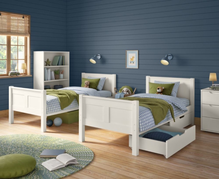 White single beds with matching storage furniture in a shared bedroom