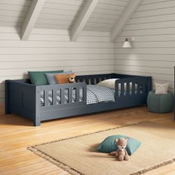 Closer view of Arven blue junior floor bed styled with gingham blue and white bedding and muted greens in a Scandinavian-style bedroom.