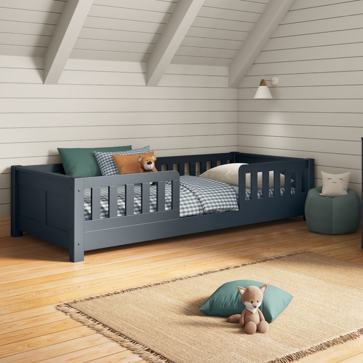 Closer view of Arven blue junior floor bed styled with gingham blue and white bedding and muted greens in a Scandinavian-style bedroom.