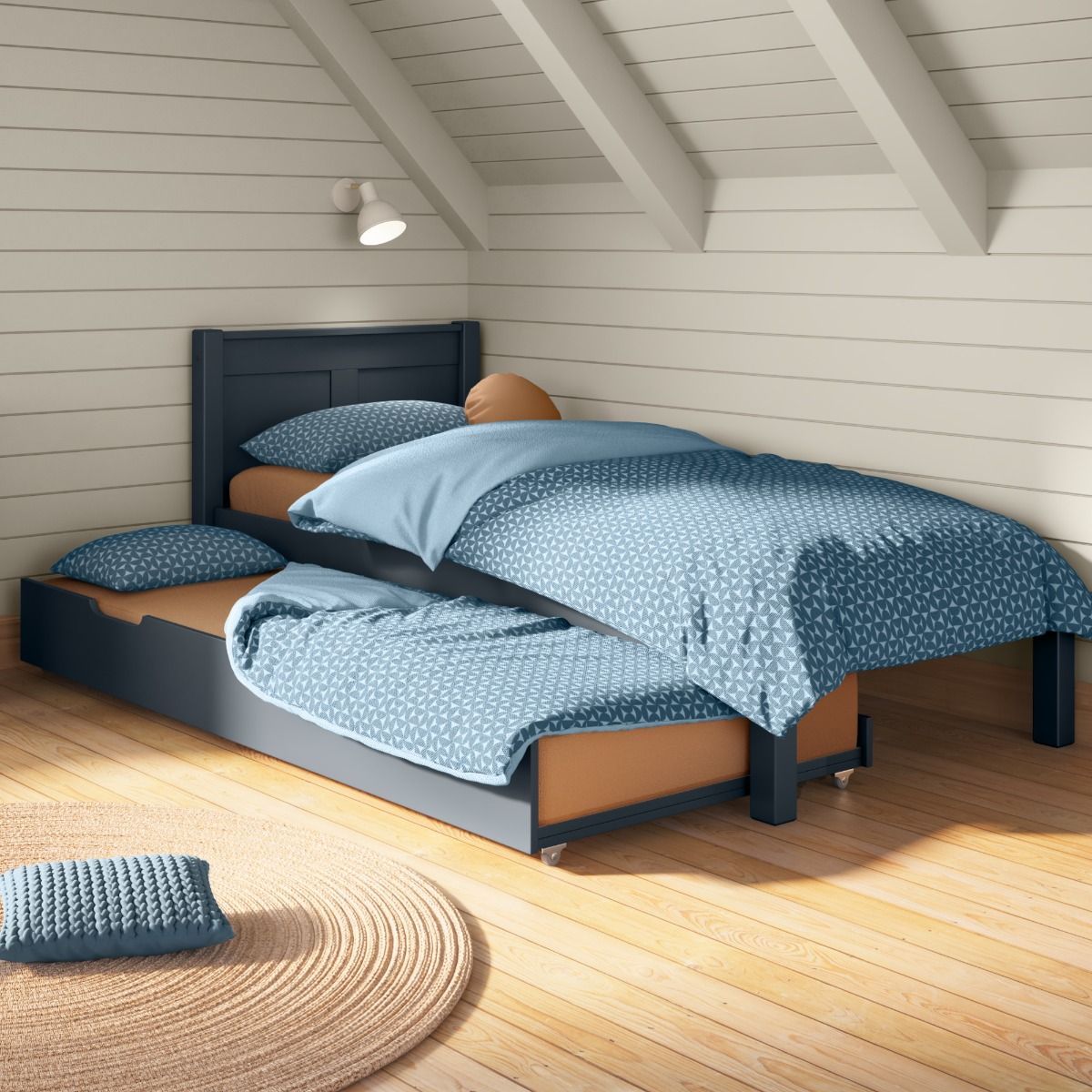Closer view of Arven blue Single Bed with Open Trundle bed and Trundle mattress styled in a Scandinavian bedroom with painted wooden walls and muted textiles.