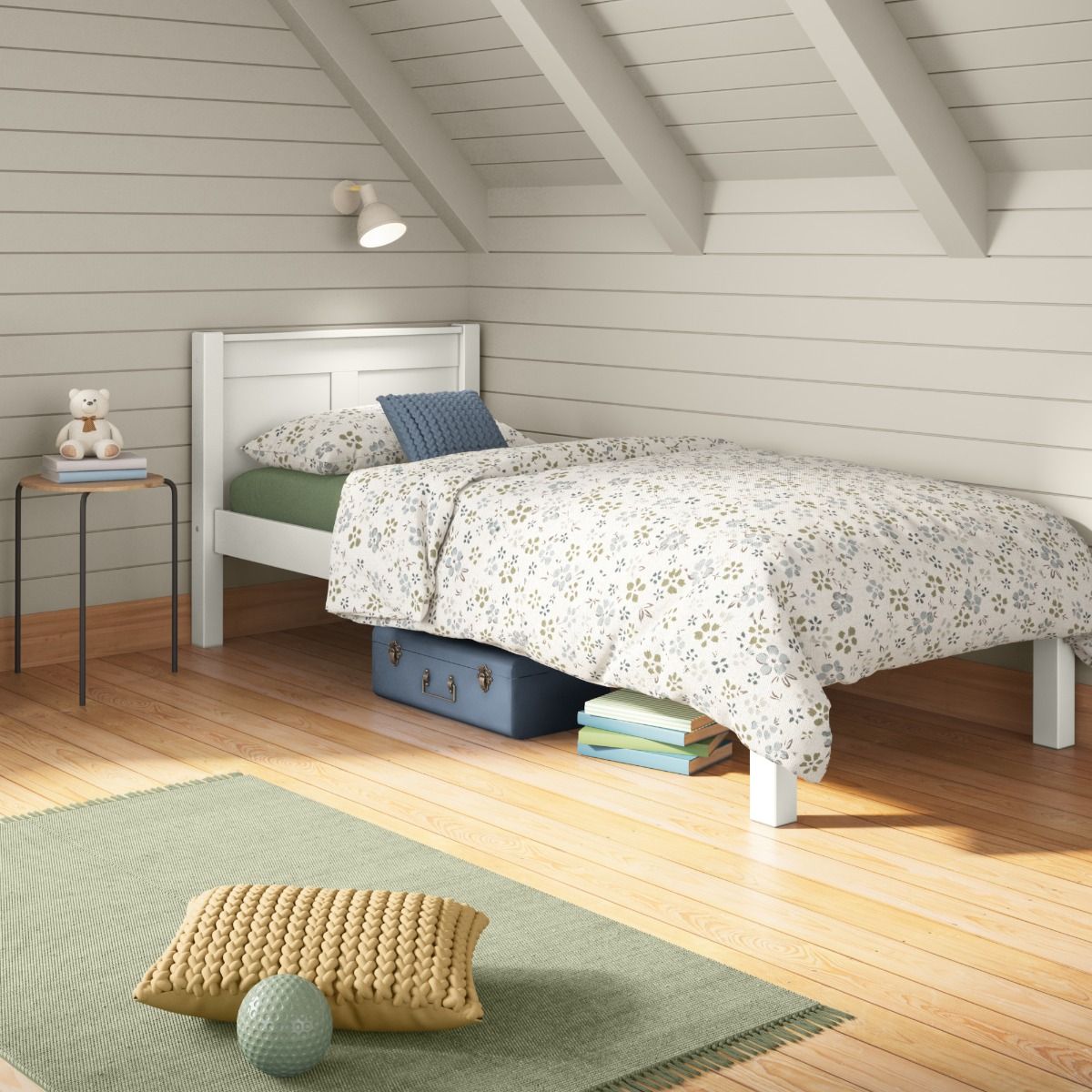 Closer view of Arven White Single bed styled with floral bedding in calm blue, green and white colours in a cosy loft bedroom painted tongue and groove panelling. 