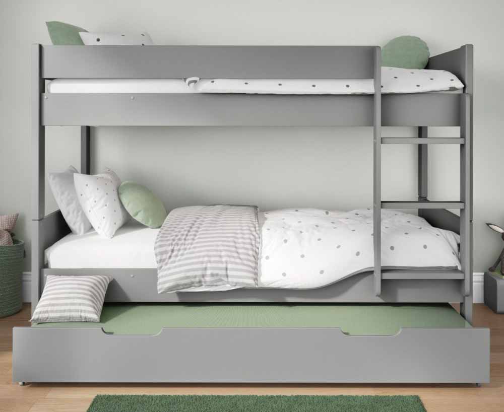A grey bunk bed with fixed ladder and a pull out trundle bed with mattress underneath the bunk bed